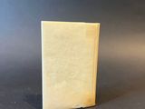 an old book sitting on top of a black table