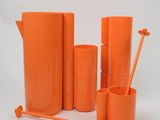 an orange pitcher, a cup, a toothbrush, and a cup holder