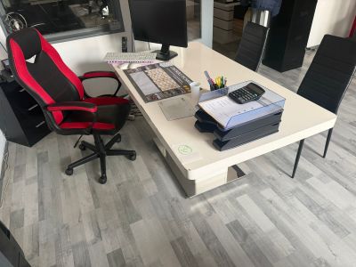 a desk with a chair and a computer on it