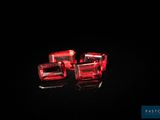 three red glass cubes sitting on top of a black surface