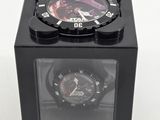 a black watch in a black box on a white surface