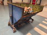 a dumpster that is sitting in the middle of the floor