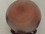 a small brown object sitting on a white surface