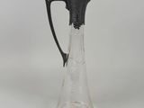 an image of a glass pitcher with a bird on the handle