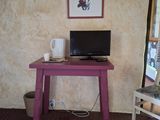 a small desk with a laptop on it in a room