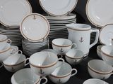 many cups and saucers sitting on a black table