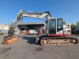 a small excavator that is parked in a parking lot