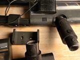 a close up of a gun on a table with a ruler