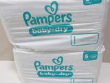 two packs of pampers baby dry diapers stacked on top of each other