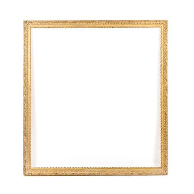 a gold frame on a white wall with a white background