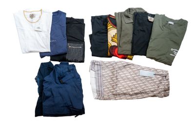 several pairs of men ' s clothing laid out on a white surface