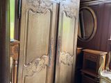 a large wooden armoire in the corner of a room