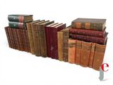 a lot of old books stacked on top of each other