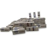 several boxes of toothpaste stacked on top of each other on a white surface