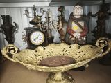 a large gold bowl with a clock on top of it