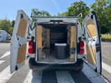 a white van with its doors open on the street