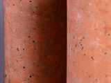 two vases sitting side by side on a gray surface
