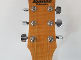 a close up of the headstock of an acoustic guitar