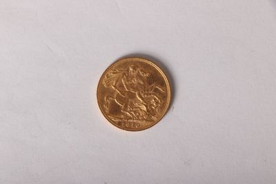 une pièce d'or sur une surface blanche avec un fond blanc