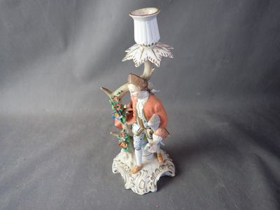 a figurine of a man with a lamp on a table