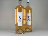 two bottles of wine sitting next to each other on a table