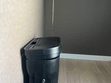 a black trash can sitting in the corner of a room
