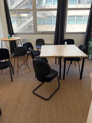 une pièce dans laquelle se trouvent une table, des chaises et un fauteuil