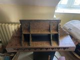 a wooden desk with a book shelf on top of it