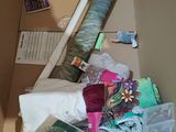 a cardboard box filled with various items that are on the floor