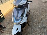 a scooter that is parked on the side of the road
