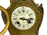 a gold clock with a picture of a man on it