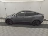 the tesla model y is parked in the garage of a building