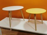 two tables that are sitting on a white table