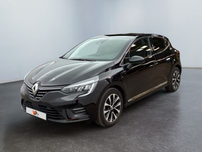 a black car is parked in a room with a white wall