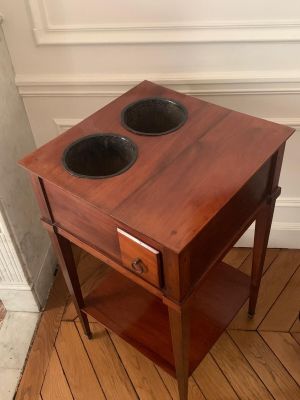 a small wooden table with two bowls on it