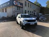 a white suv parked in front of a building