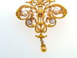 an image of a gold brooch with a pearl and diamond pendant