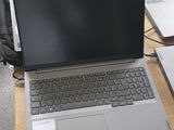 many laptops sitting on a table in a room