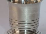 a silver cup that is sitting on top of a table