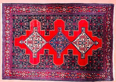 a red and blue rug with geometric designs on it