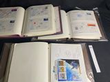 three open books sitting on top of a black table next to each other