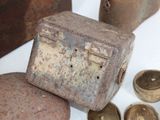 a small metal box sitting on a table next to other items