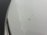 a close up of a car ' s hood with scratches on it