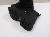 a pair of black boots sitting on a white table