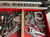 a red tool box filled with various tools on the floor