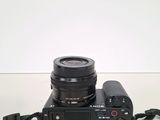 a camera with a lens attached to it on a table