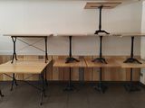three tables and two benches in the corner of a room