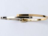 Bracelet rigide bicolore or et argent avec un fermoir carré