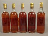 six bottles of wine are lined up in a row