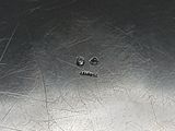 a silver plate with a hole in the middle of it